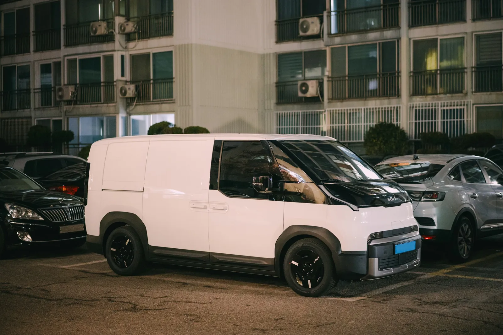 A white delivery van parked at night