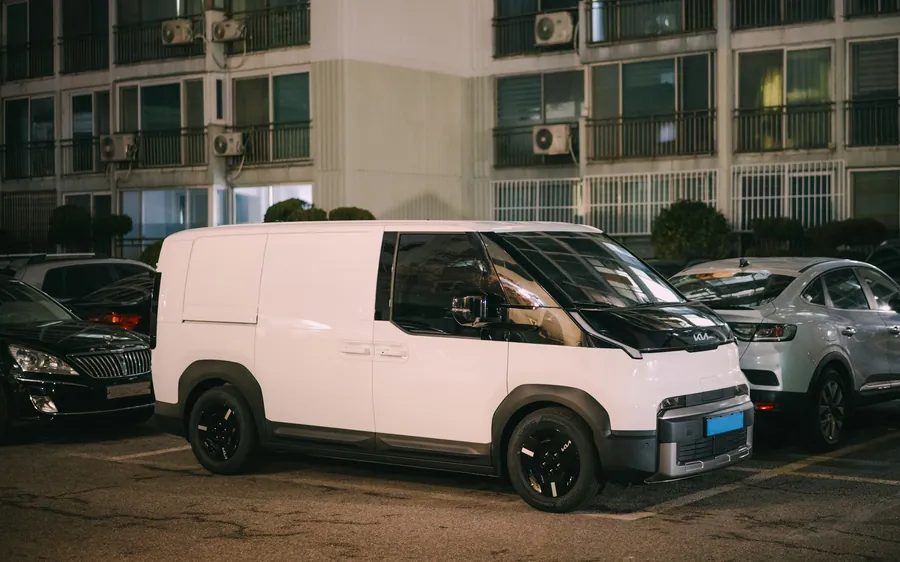 A white delivery van parked at night