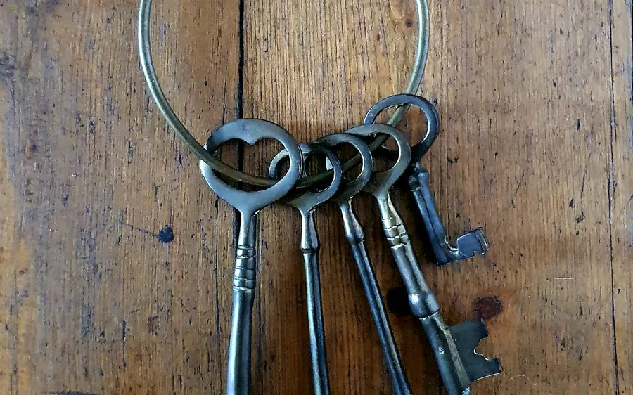 A ring of old keys on a wooden table