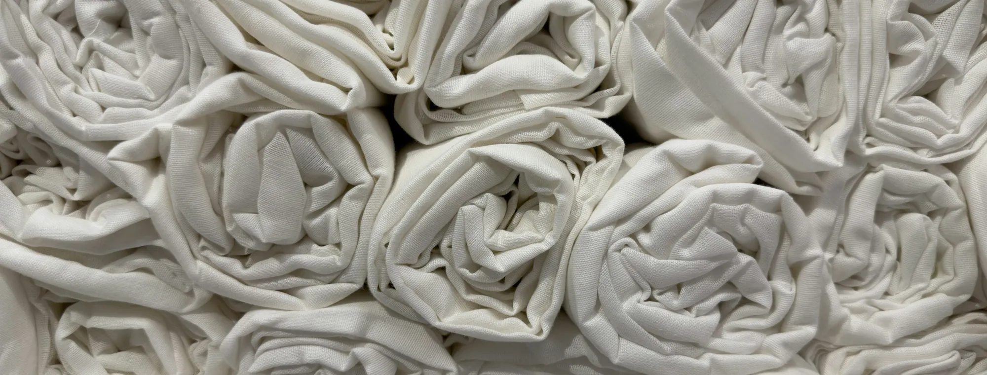 Rolled white table linen, close up